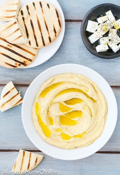 Easy Mustard Hummus in a bowl over a blue wooden surface.