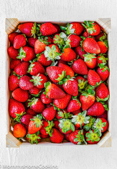 Fresh strawberries in a wooden basket.
