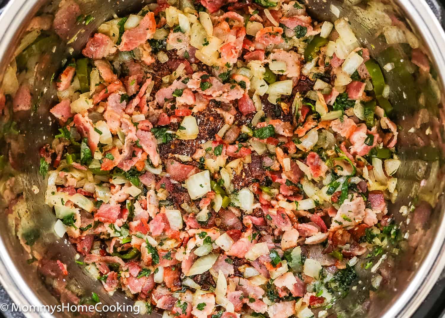 saute bacon, onion, peppers, and garlic in a pot.