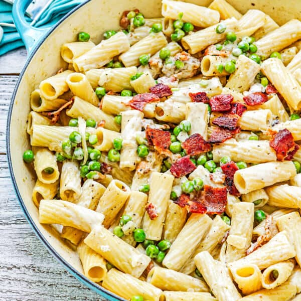 One-Pot Creamy Bacon Alfredo Pasta with peas in a large pot.