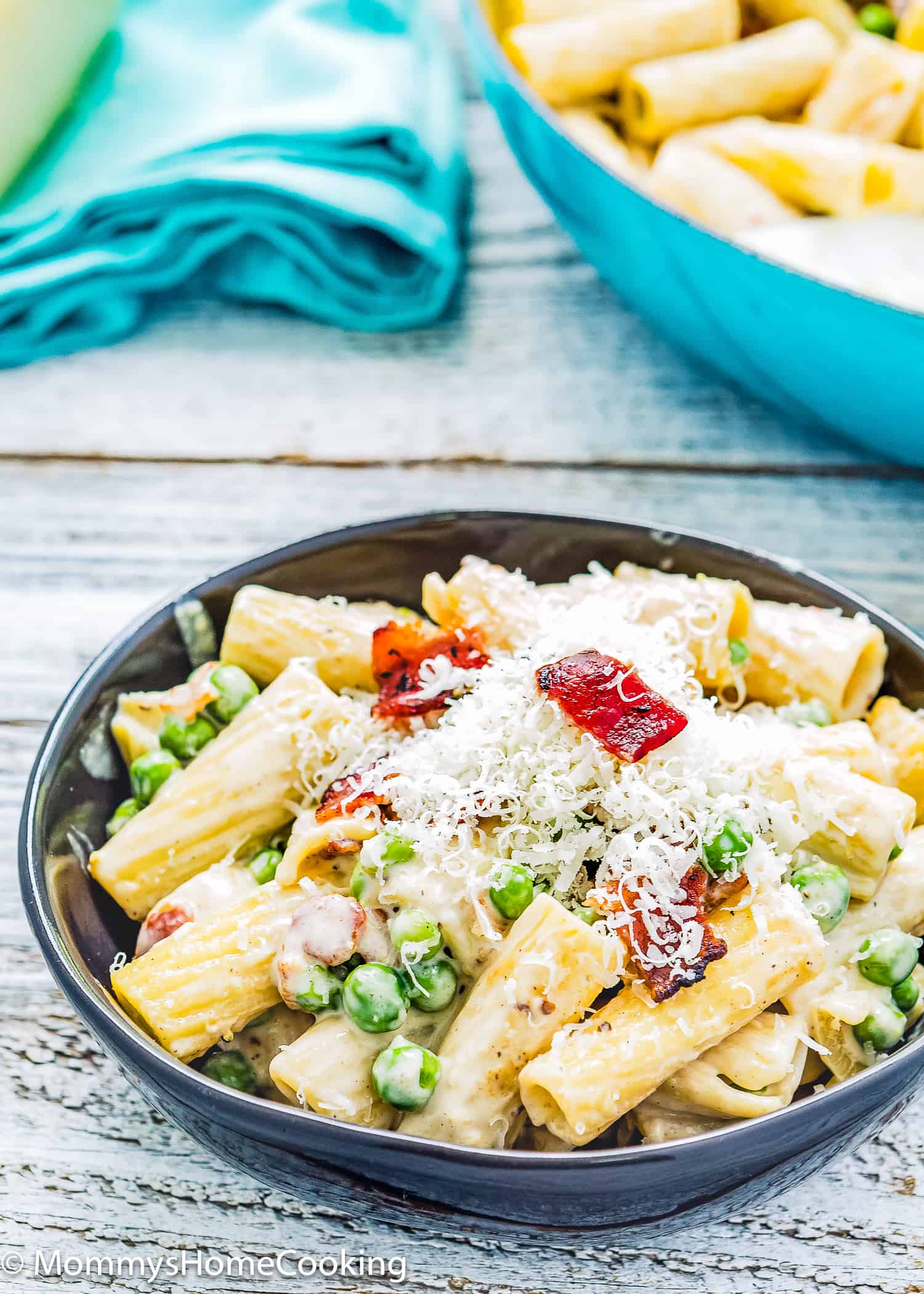 One-Pot Creamy Bacon Alfredo Pasta in a black bowl with grated parmesan on top.