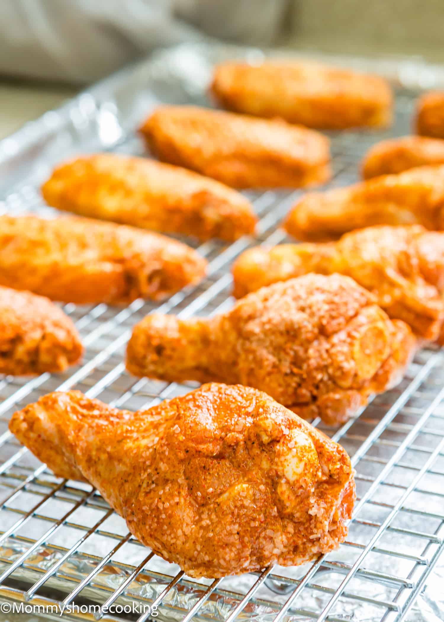 Chipotle Chicken Wings over a cooling rack on a baking sheet.