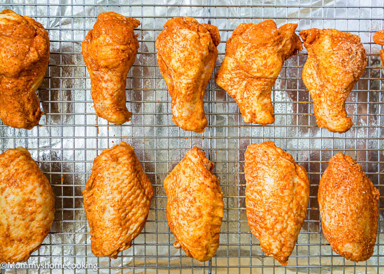 Baked Wings over a cooling rack on a baking sheet.