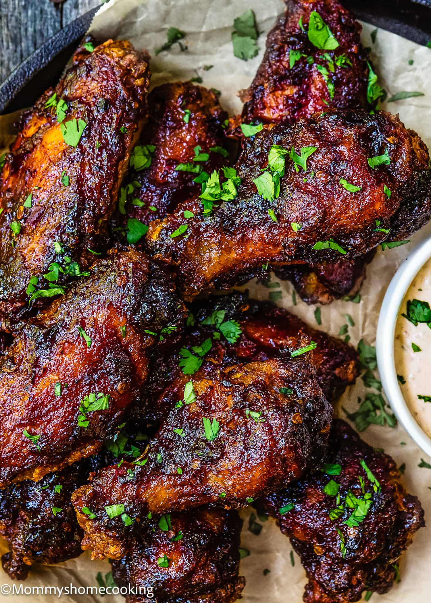 Chipotle Chicken Wings on a plate with chipotle sauce on the side.