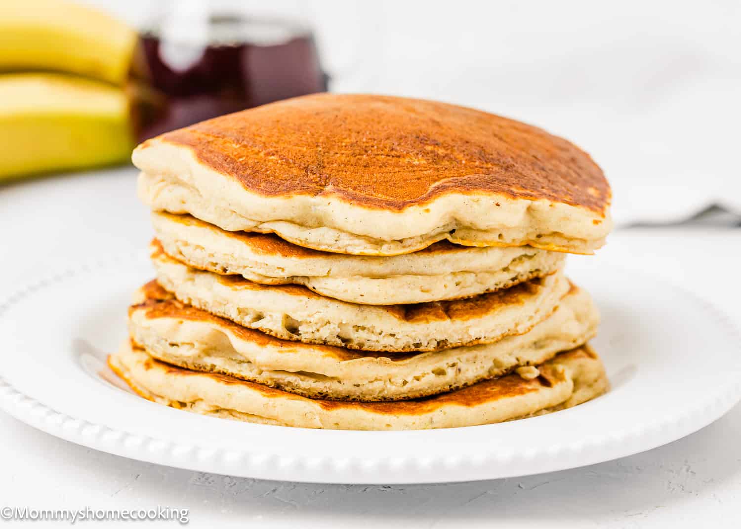 a stack of easy banana pancakes made with no egg on a white plate.