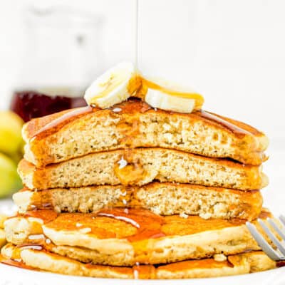 a stack of easy banana pancakes made with no egg cut showing their fluffy interior texture.