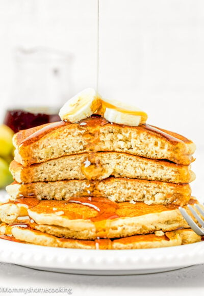 a stack of easy banana pancakes made with no egg cut showing their fluffy interior texture.