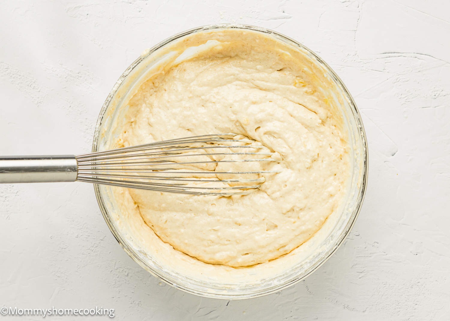 Egg-free Banana Pancakes batter in a bowl with a whisk.