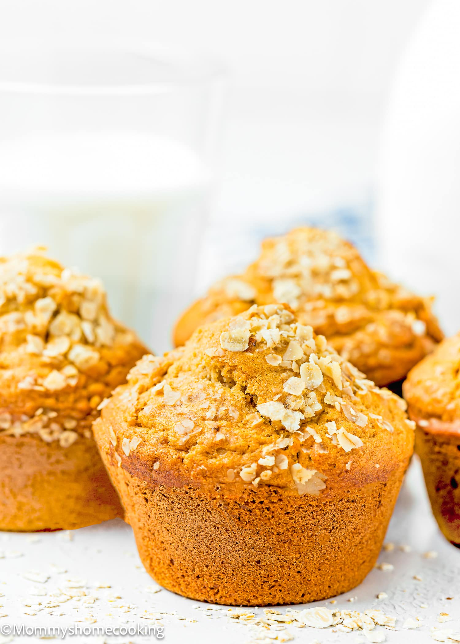 Moist easy Vegan oat muffins with oats and no sugar, served with a glass of milk.