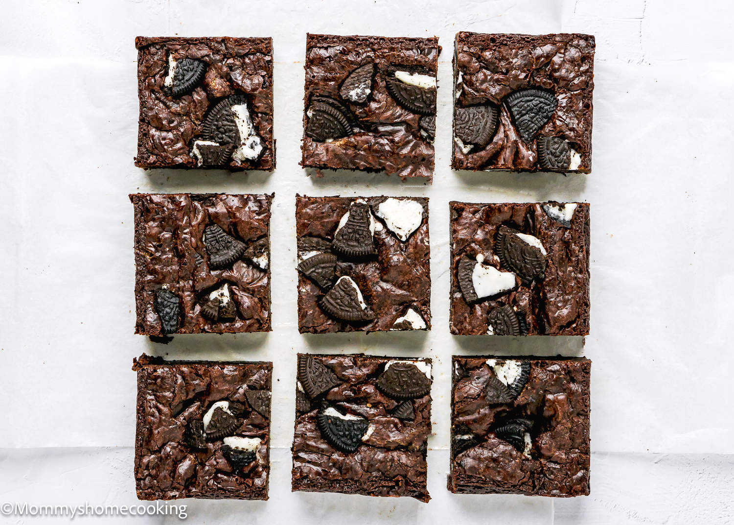 cut Eggless Oreo brownies on a white surface.