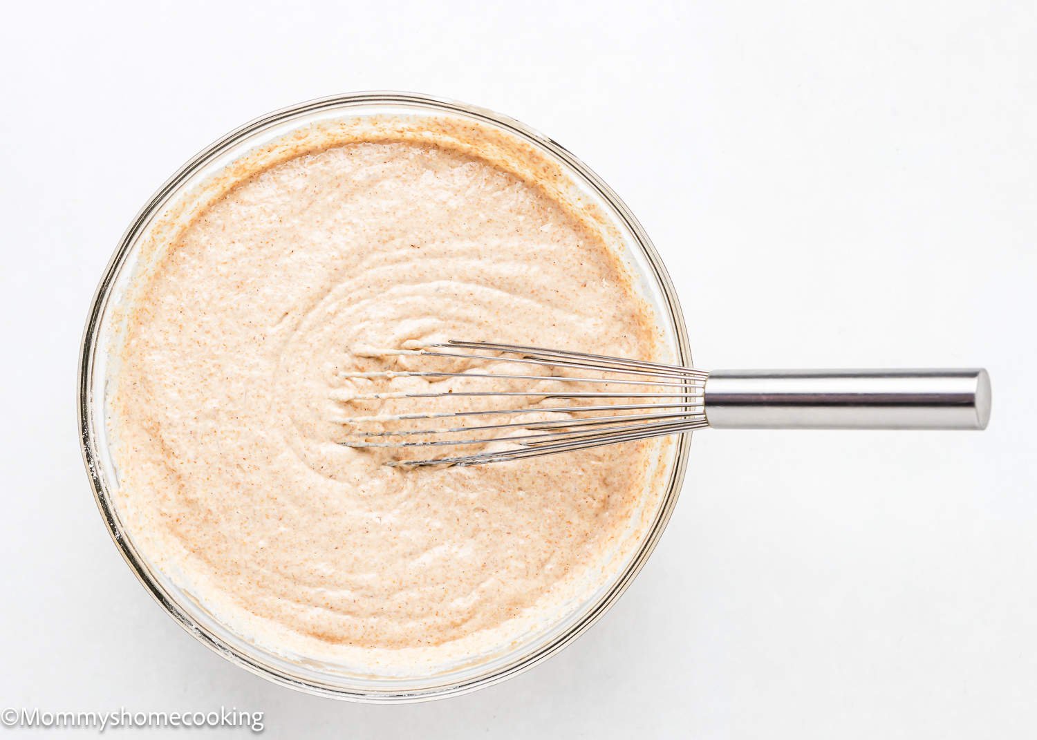 egg-free Whole Wheat Pancakes batter in a bowl with a wisk.
