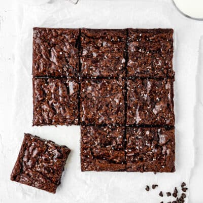 boxed Chocolate brownies with sea salt on a white background made without eggs.