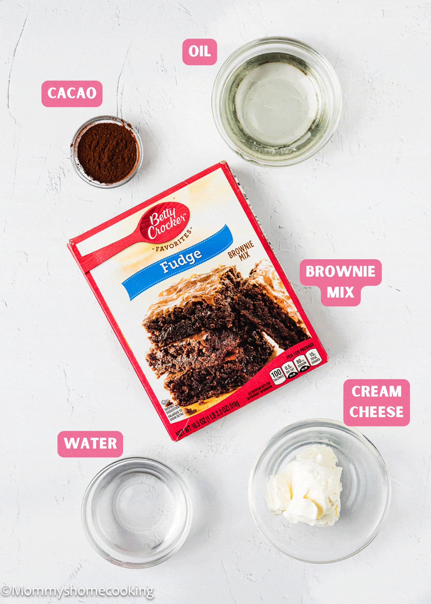 The ingredients for boxed brownies made without eggs are shown on a white surface.