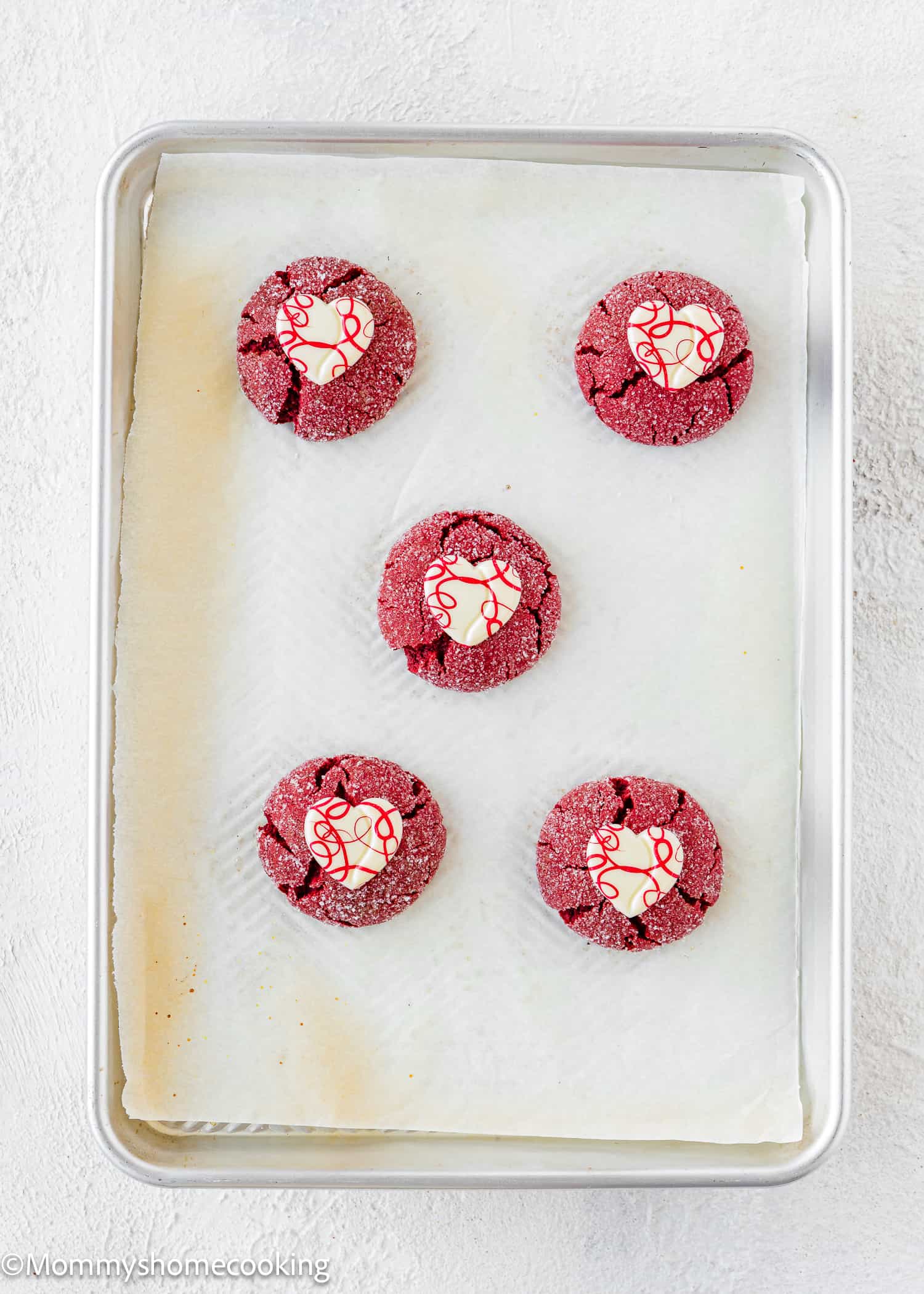 baked Cake Mix Valentine Cookies in a baking sheet topped with white chocolate hearts.