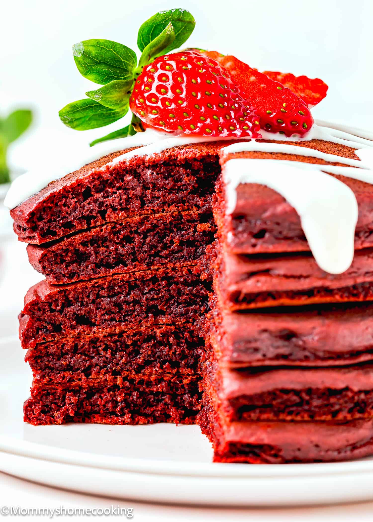 cut five egg-free red velvet pancakes stack showing their fluffy inside texture.