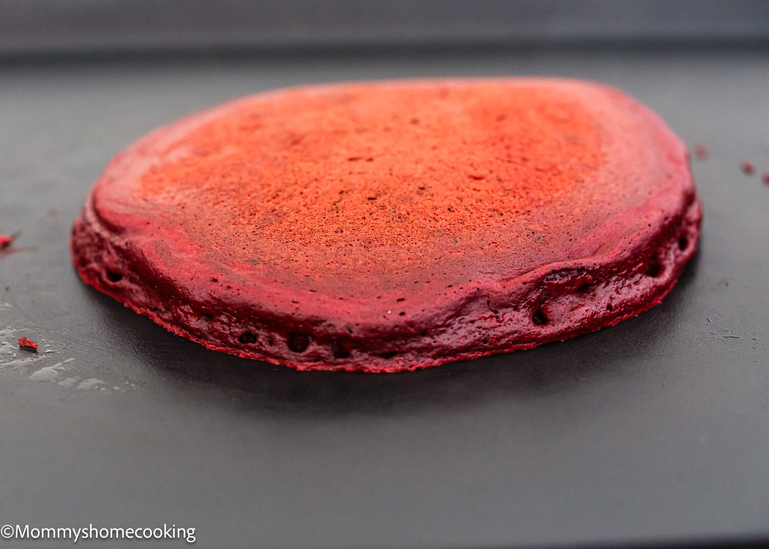 a red velvet pancakes on a pancake griddle.
