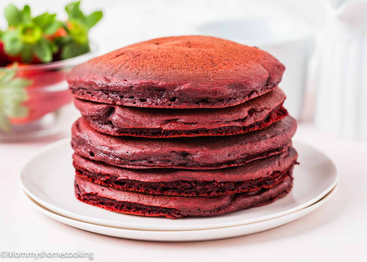 five egg-free red velvet pancakes on a plate.