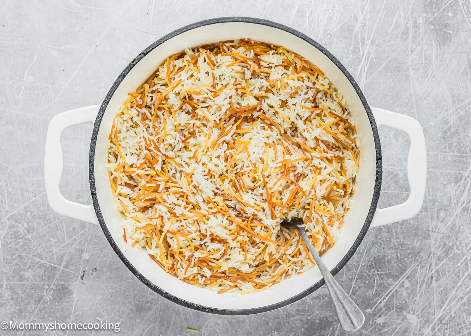 Vermicelli Rice (Arroz con Fideos) in a dutch oven pot with fork.