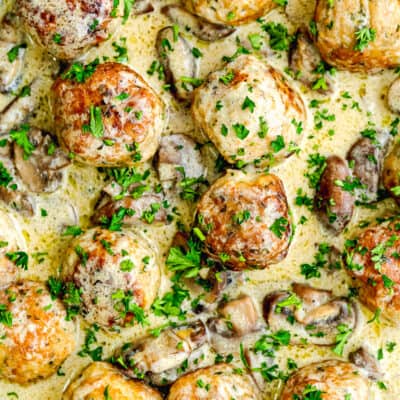 Stroganoff Meatballs with creamy sauce garnished with parsley.