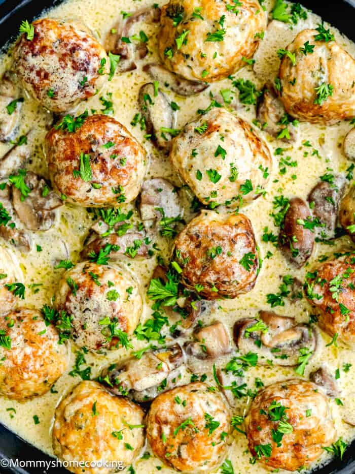 Stroganoff Meatballs with creamy sauce garnished with parsley.
