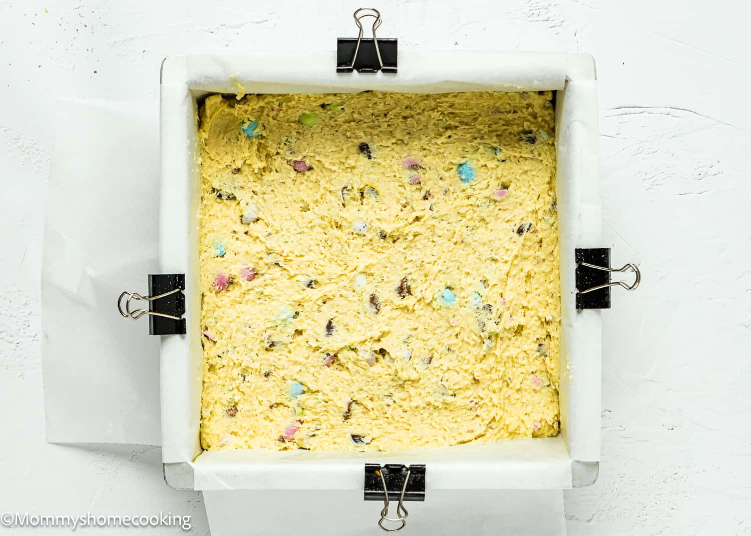 unbaked Easter Blondies (Egg-Free) batter in a square baking pan.