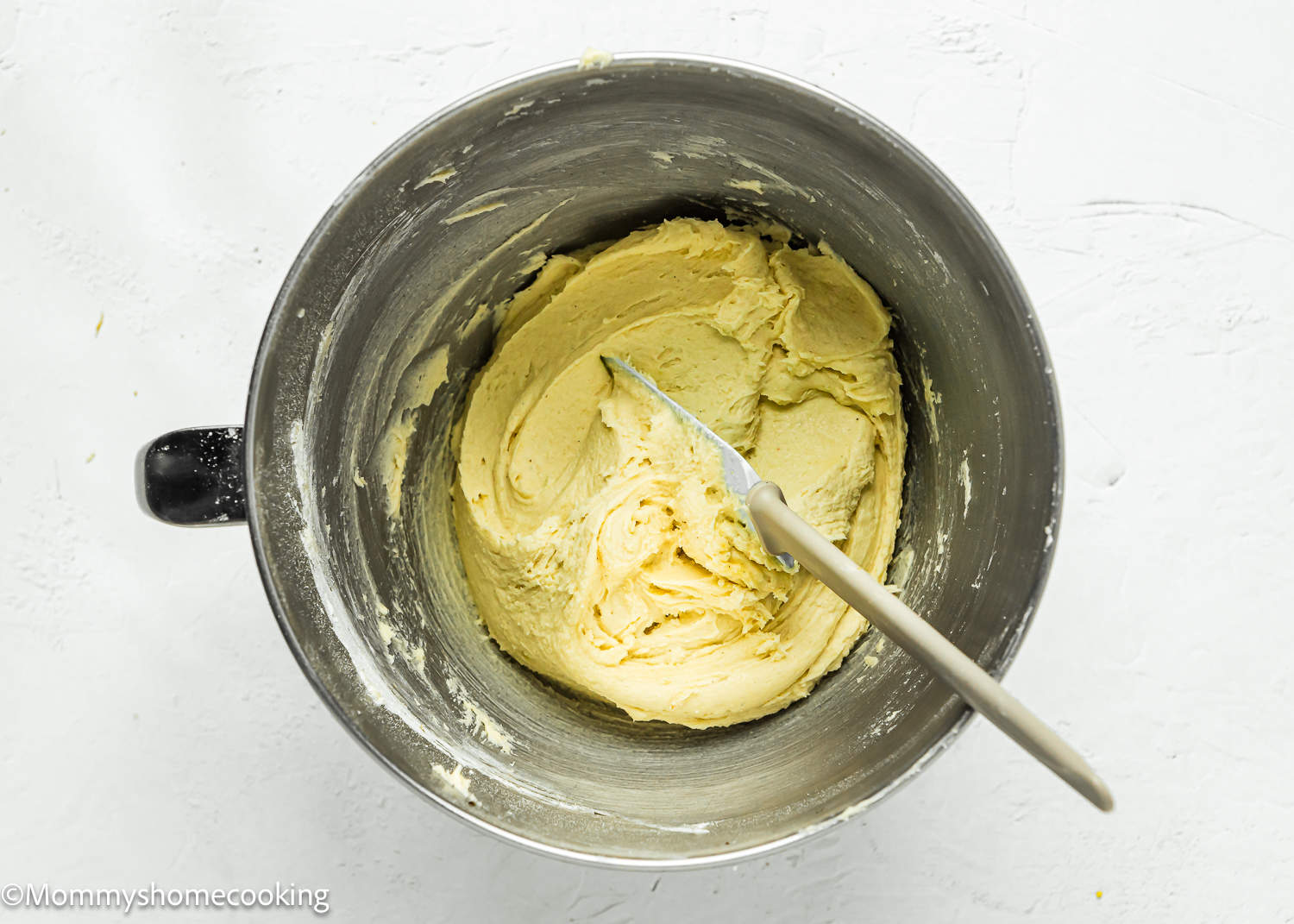 egg-free blondies batter in stand mixer bowl with a spatula.