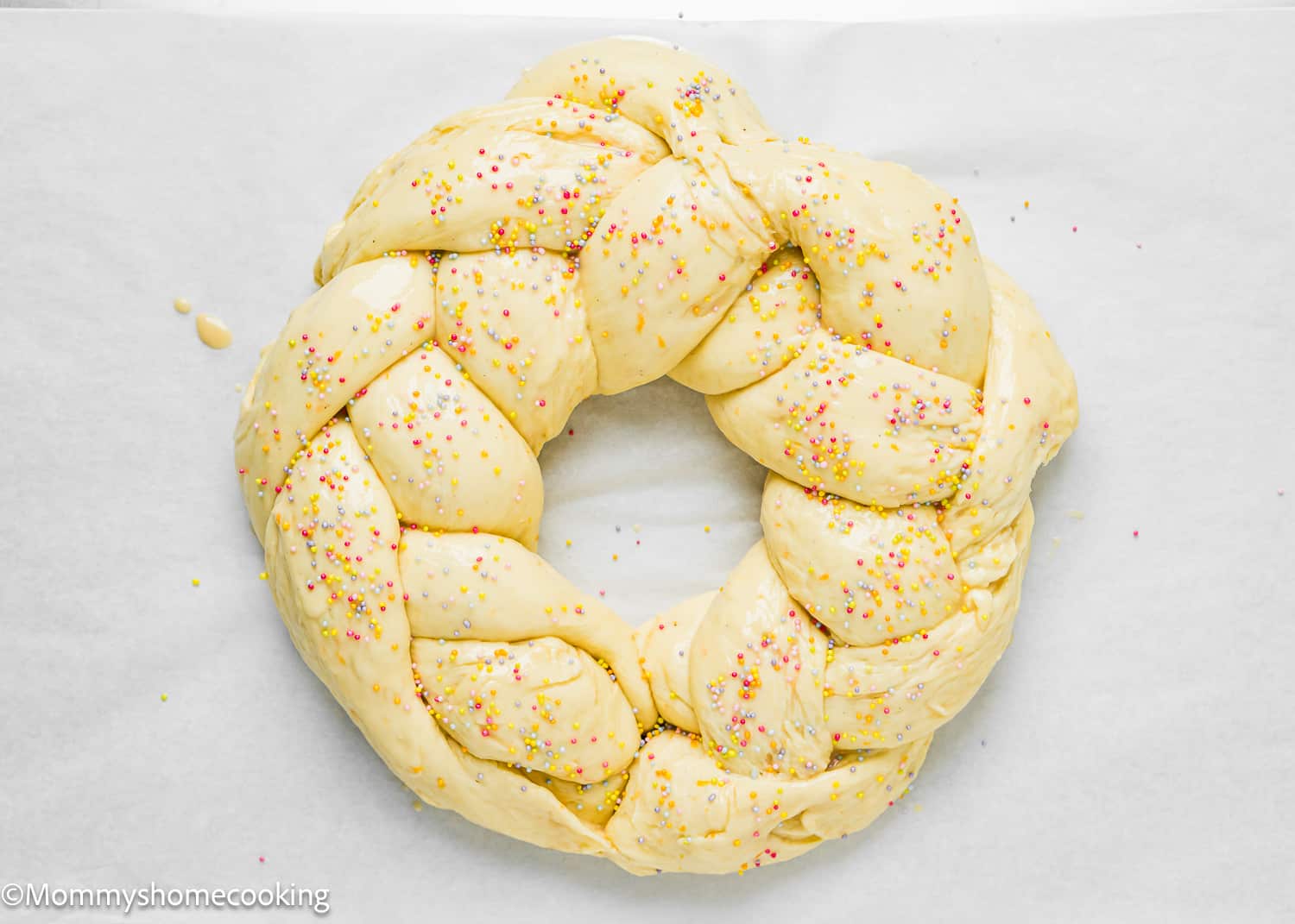 unbaked Easter Sweet Bread with sprinkles over a baking tray.