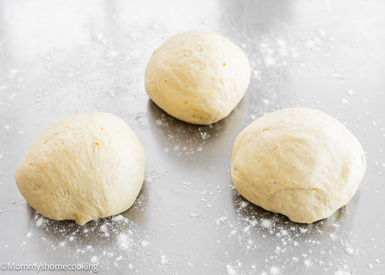 three portions of unbaked Easter Sweet Bread dough.