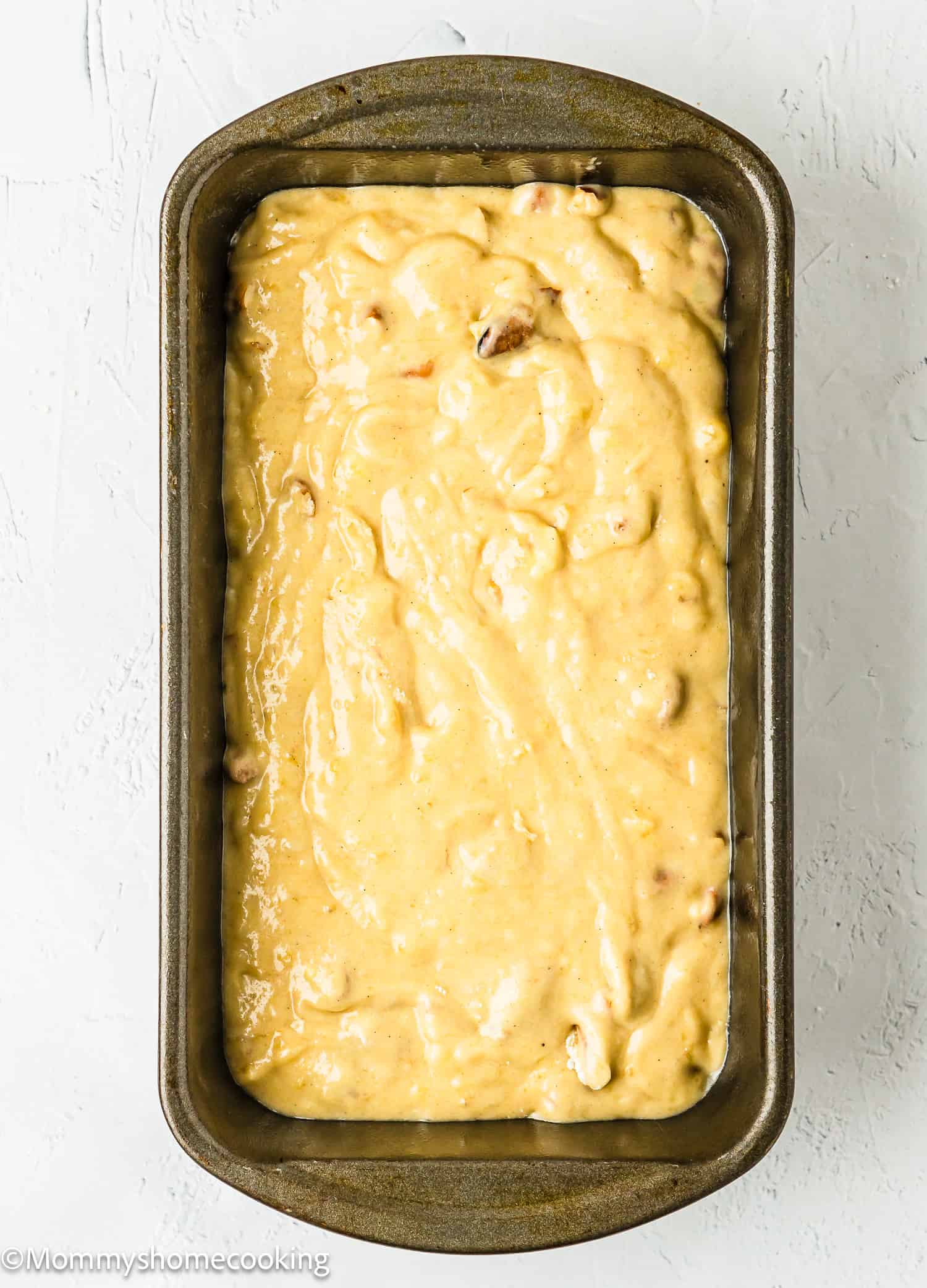 Easy Banana Nut Bread Without Eggs batter in a loaf pan.