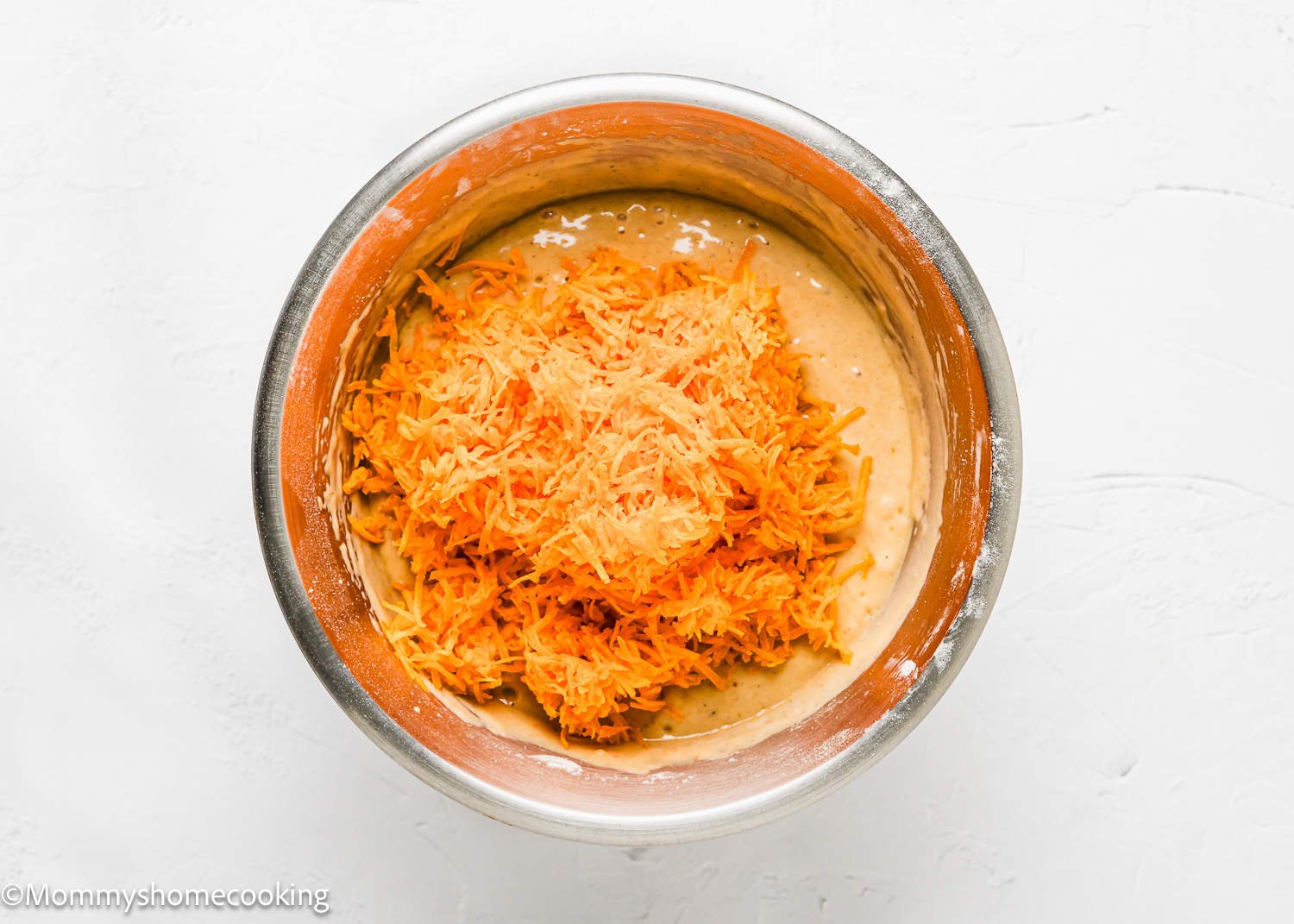 Easy Carrot Cake Snack Cake (No Eggs – No Dairy) batter with grated fresh carrots in top in a bowl.