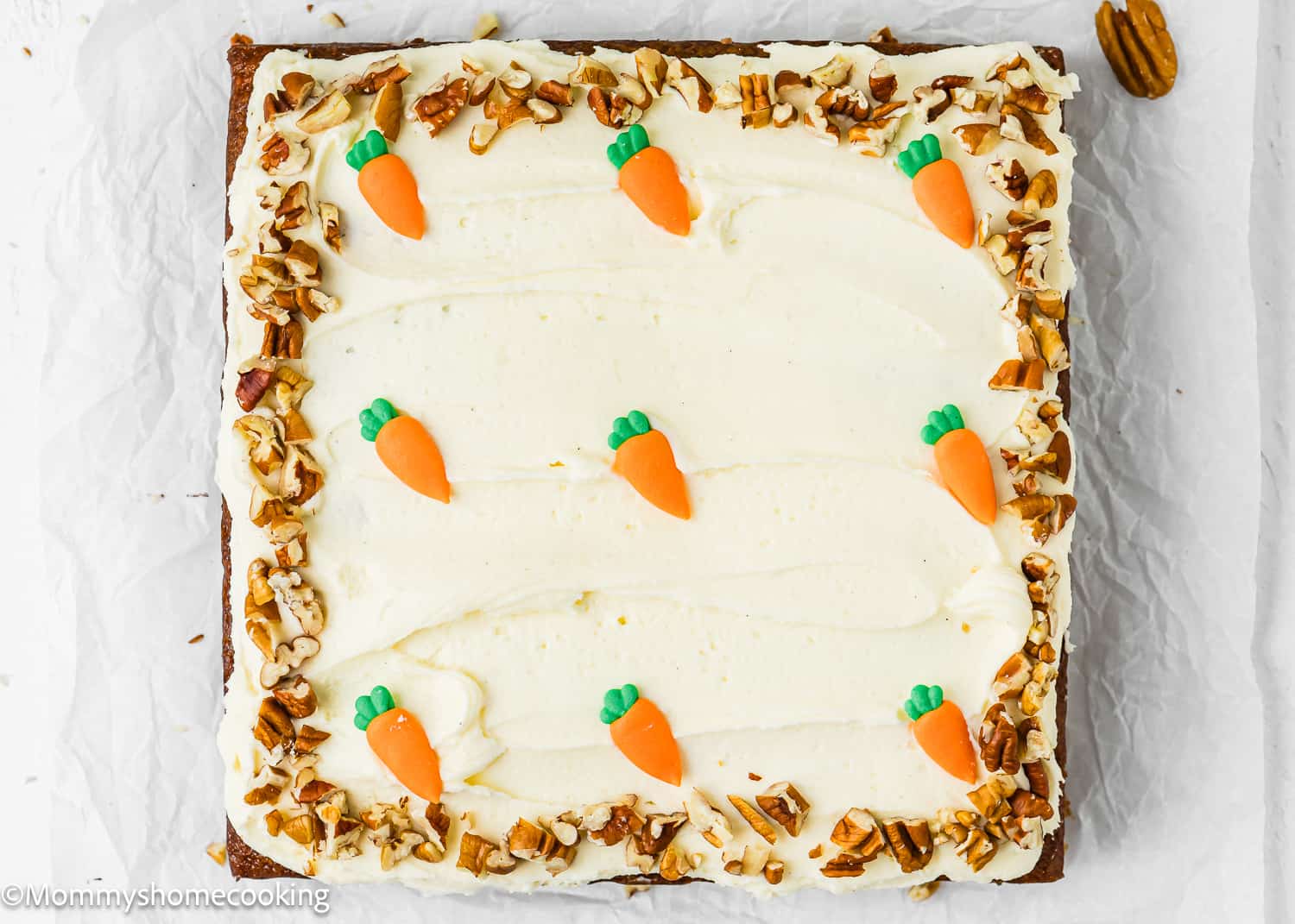 A whole Easy Carrot Cake Snack Cake (No Eggs – No Dairy) over a piece of parchment paper.