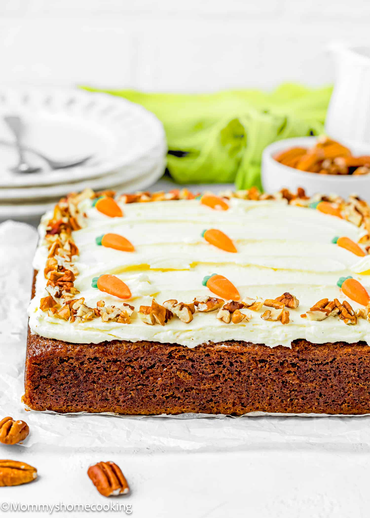 a whole Easy Carrot Cake Snack Cake (No Eggs – No Dairy) with cream cheese frosting , pecans and sugar carrots.