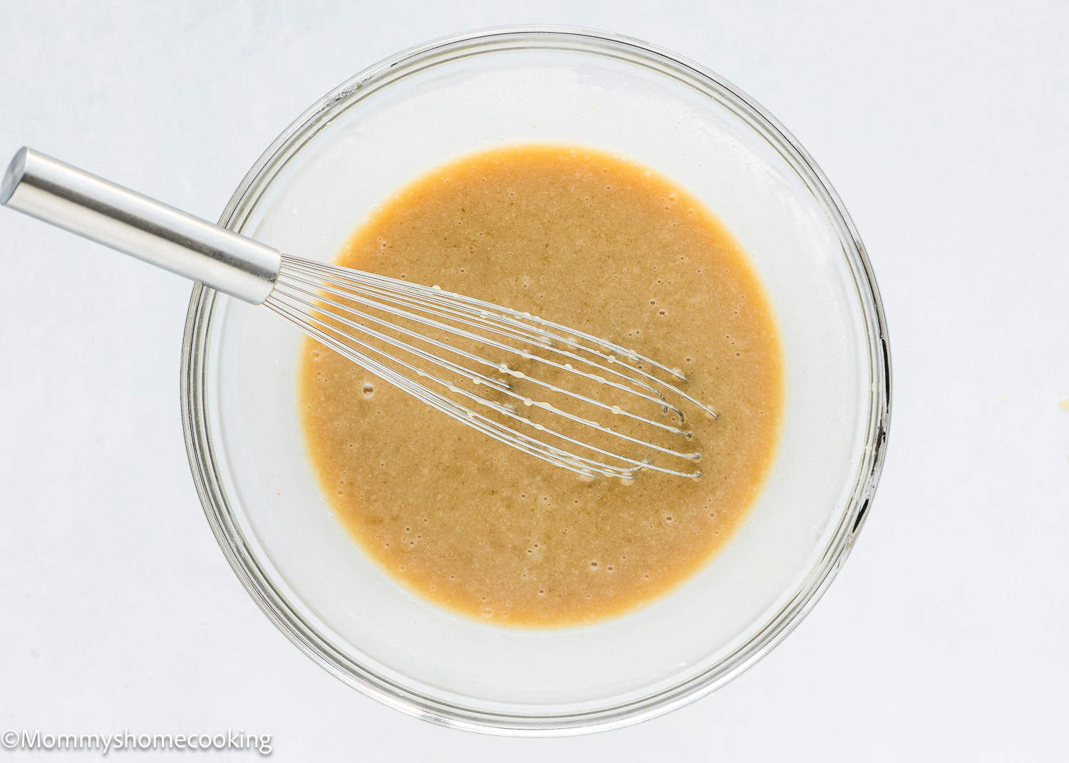 wet ingredients to make Easy Carrot Cake Snack Cake (No Eggs – No Dairy) in a bowl with a whisk.