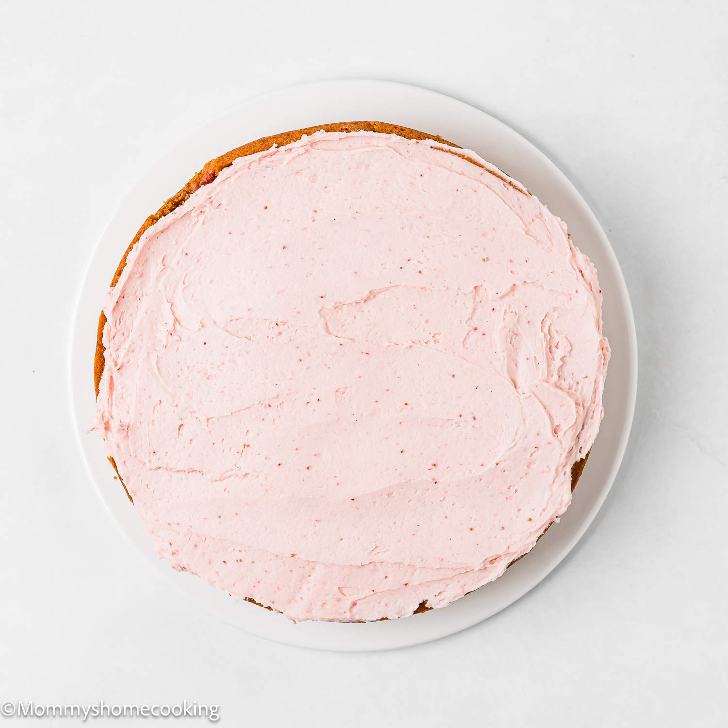 a layer Easy Fresh Strawberry Cake topped with strawberry frosting.