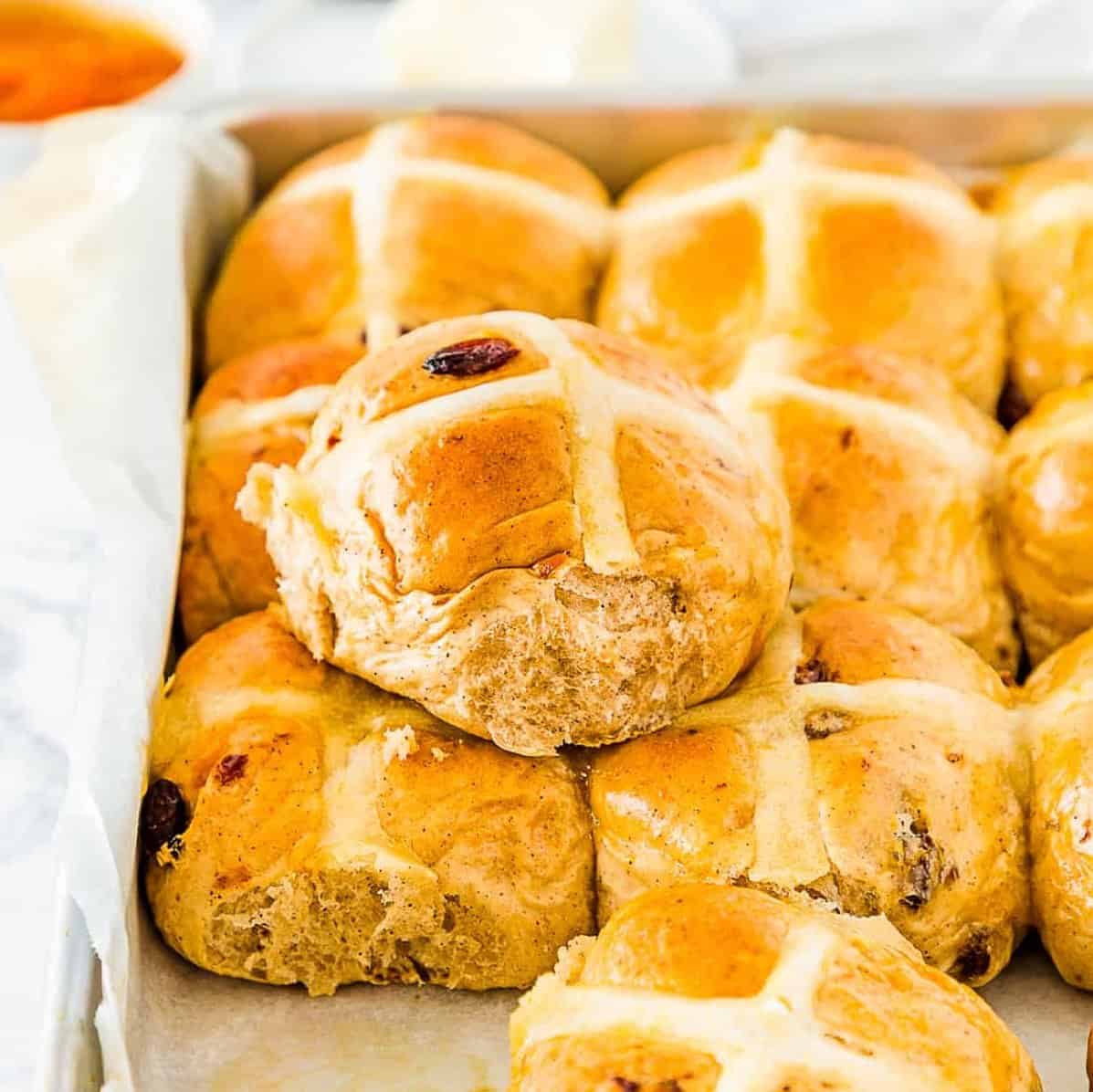 Eggless Easter Hot Cross Buns in a baking tray.