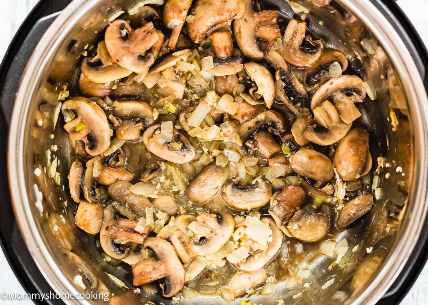 sautéed onions, garlic and mushrooms in a pot.