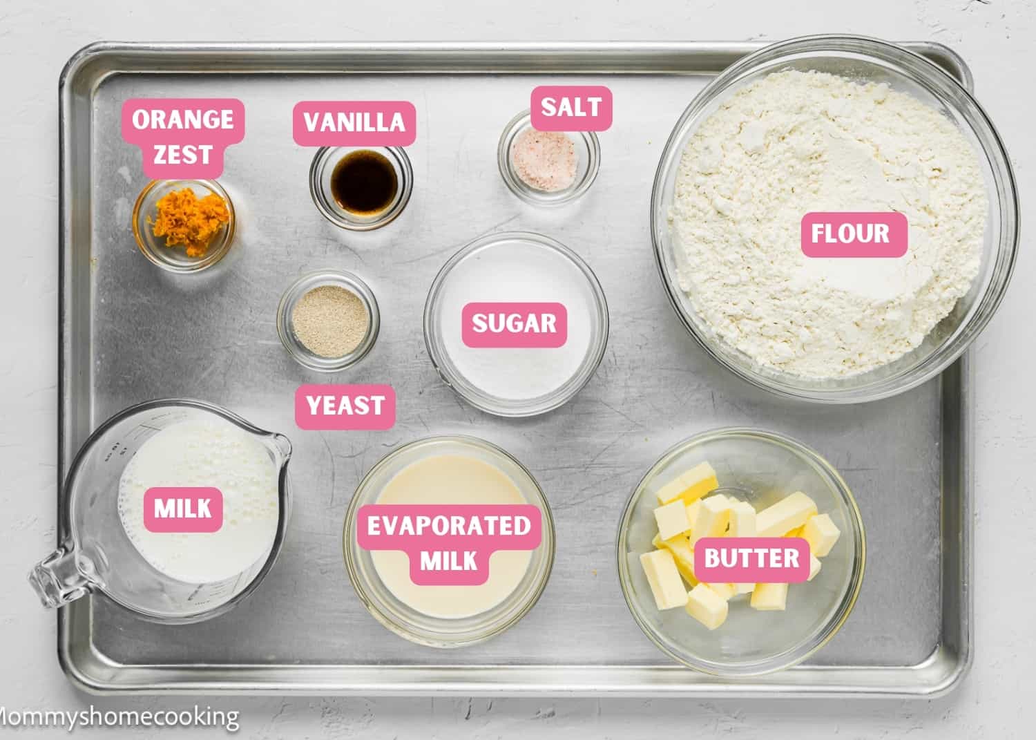 Ingredients needed to make Easter Sweet Bread dough over a baking tray.