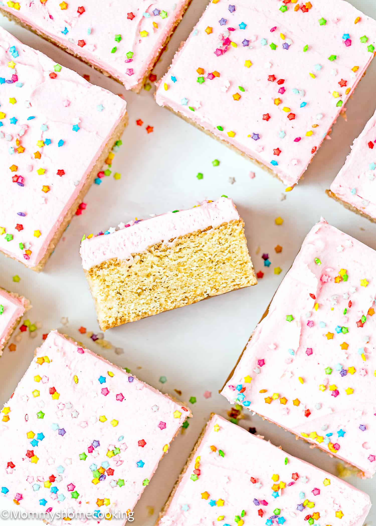 an Eggless Sugar Cookie bar showing its perfect cakey texture with more bars around it.