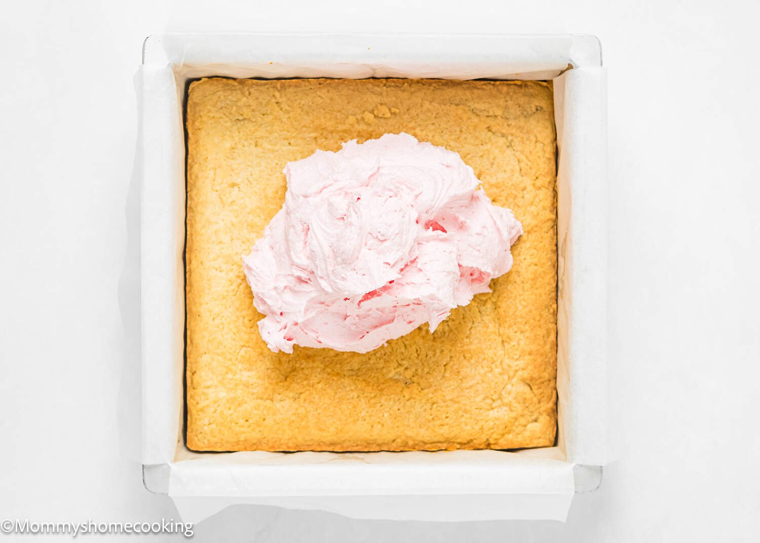 pink frosting over a slab of egg-free sugar cookie bars.