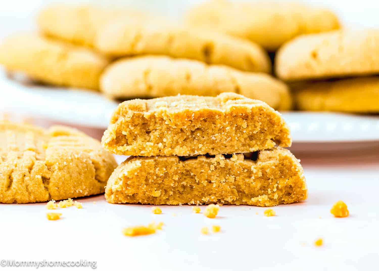 one egg-free Peanut Butter Cookie cut in half showing its soft and thick texture.