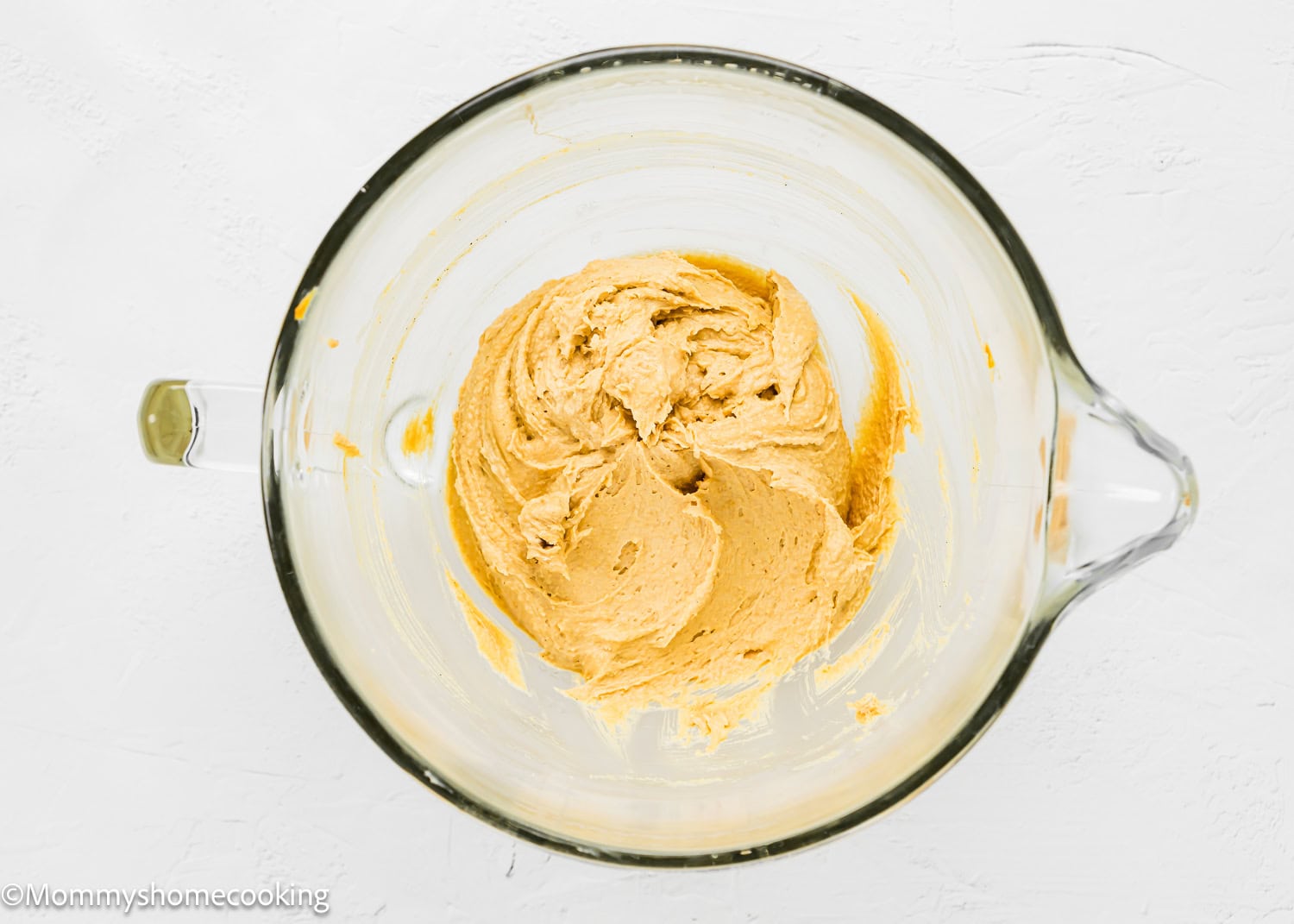 wet ingredients to make egg-free Peanut Butter Cookie dough on a mixer's bowl.