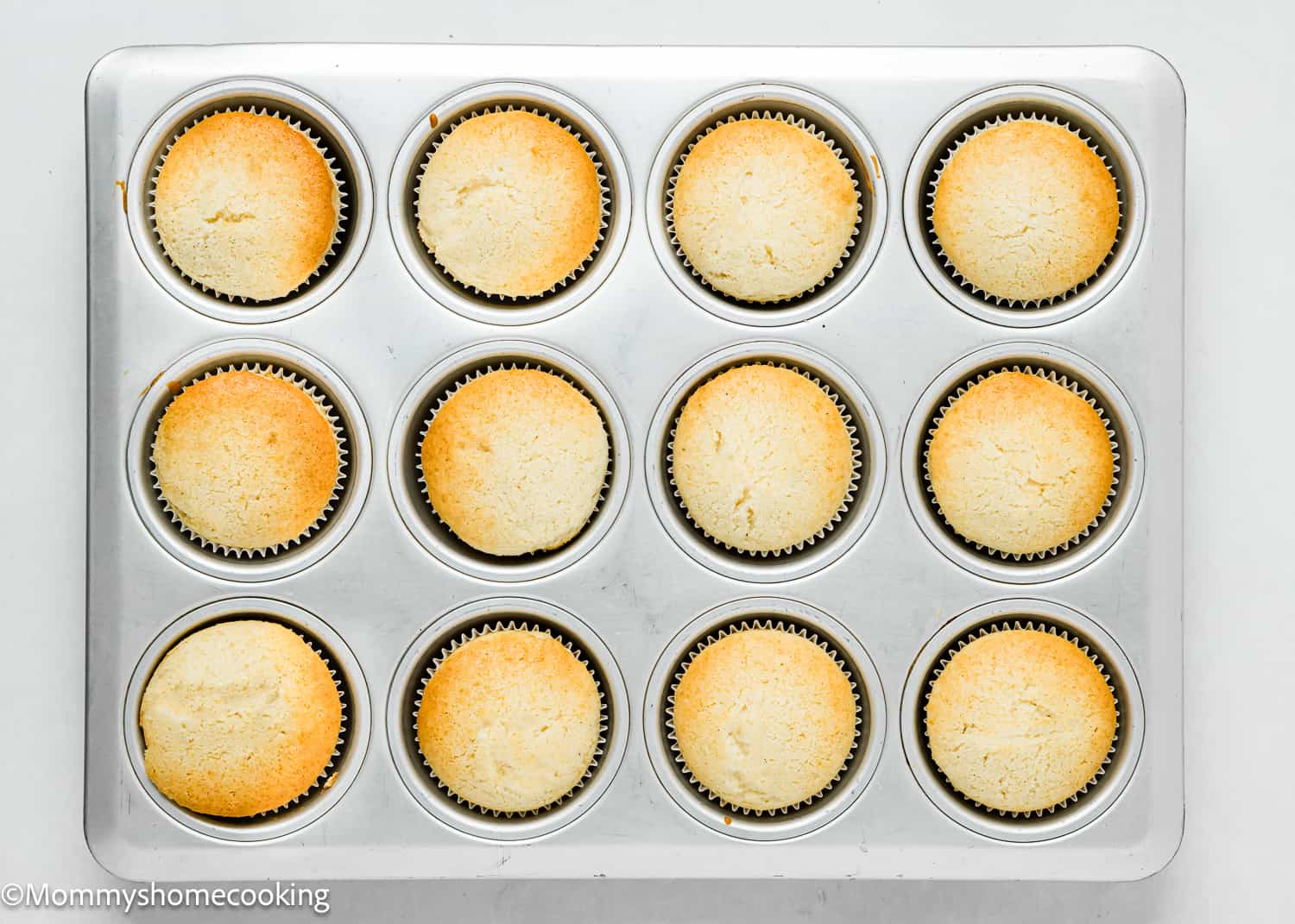 baked dairy-free and egg-free Vanilla Cupcakes in a cupcake pan.
