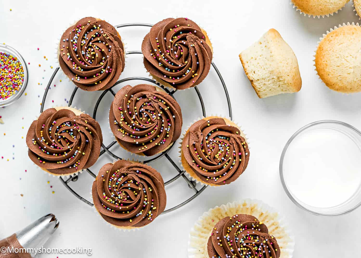 overhead view of a dairy-free and egg-free Vanilla Cupcakes with chocolate frosting and sprinkles.