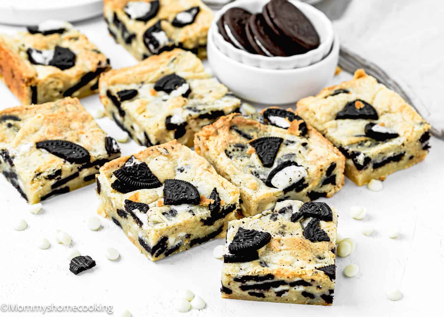 Easy Oreo Blondies over a white surface with a bowl with oreos on the back.