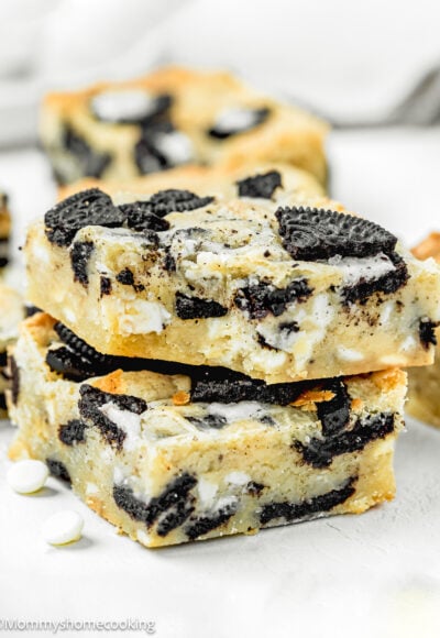 Stack of two Easy Oreo Blondies (Egg-Free) on a white surface.