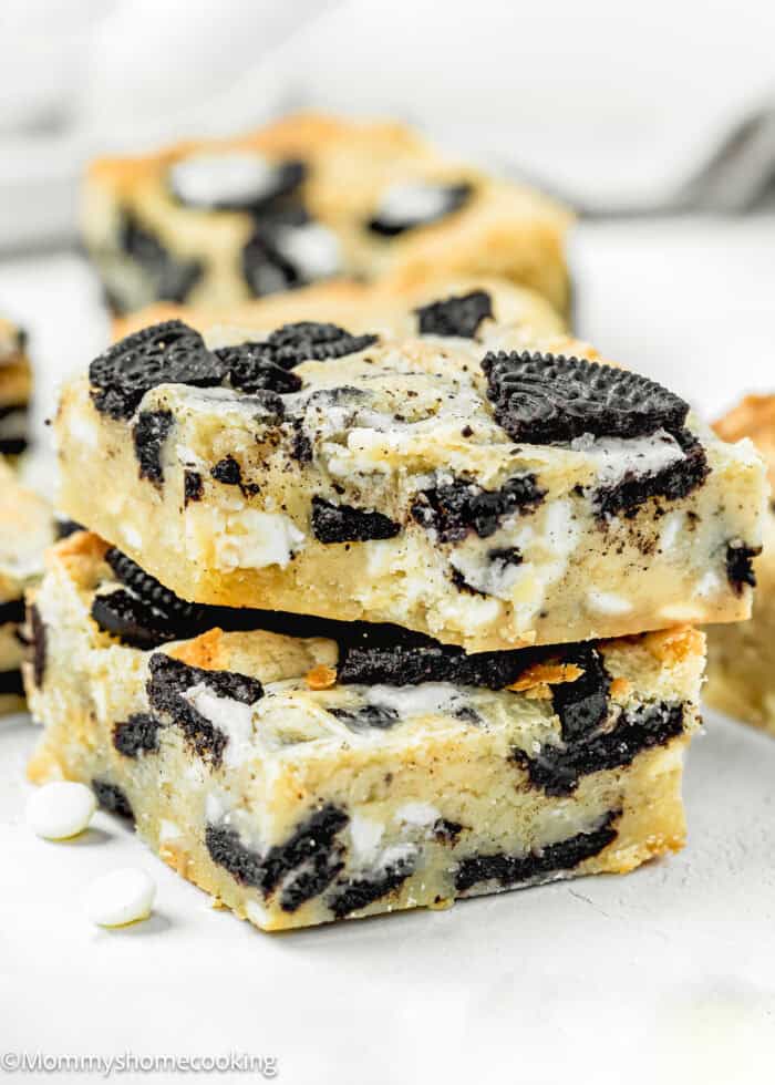 Stack of two Easy Oreo Blondies (Egg-Free) on a white surface.