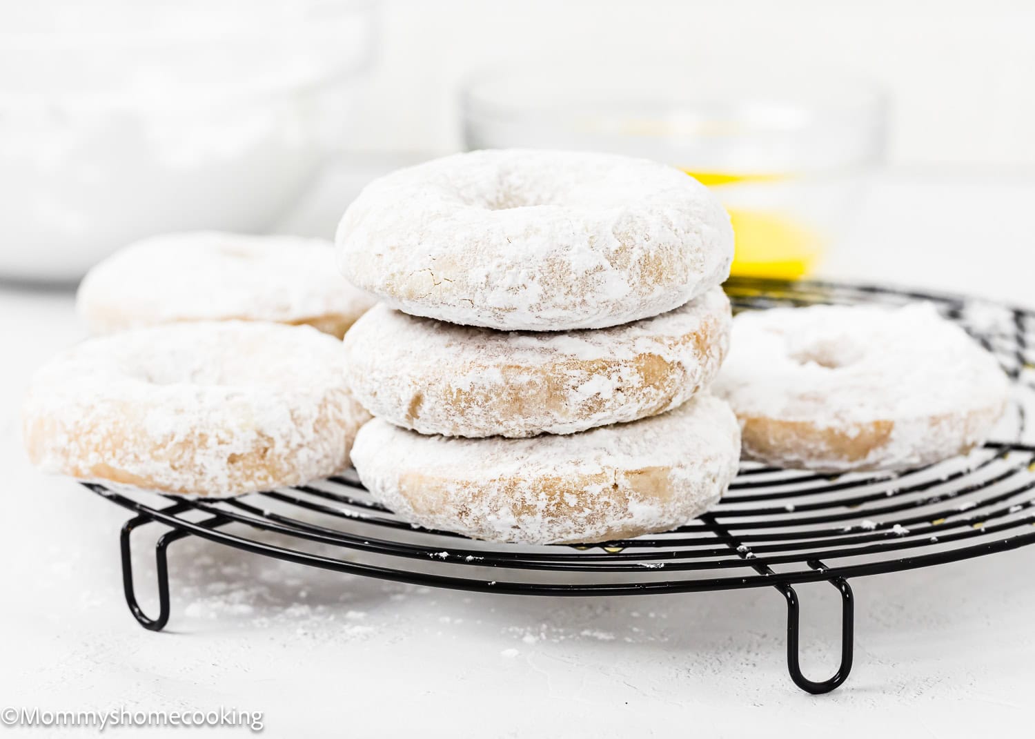 Eggless Old Fashioned Powdered Sugar Donuts over a cooling rack.