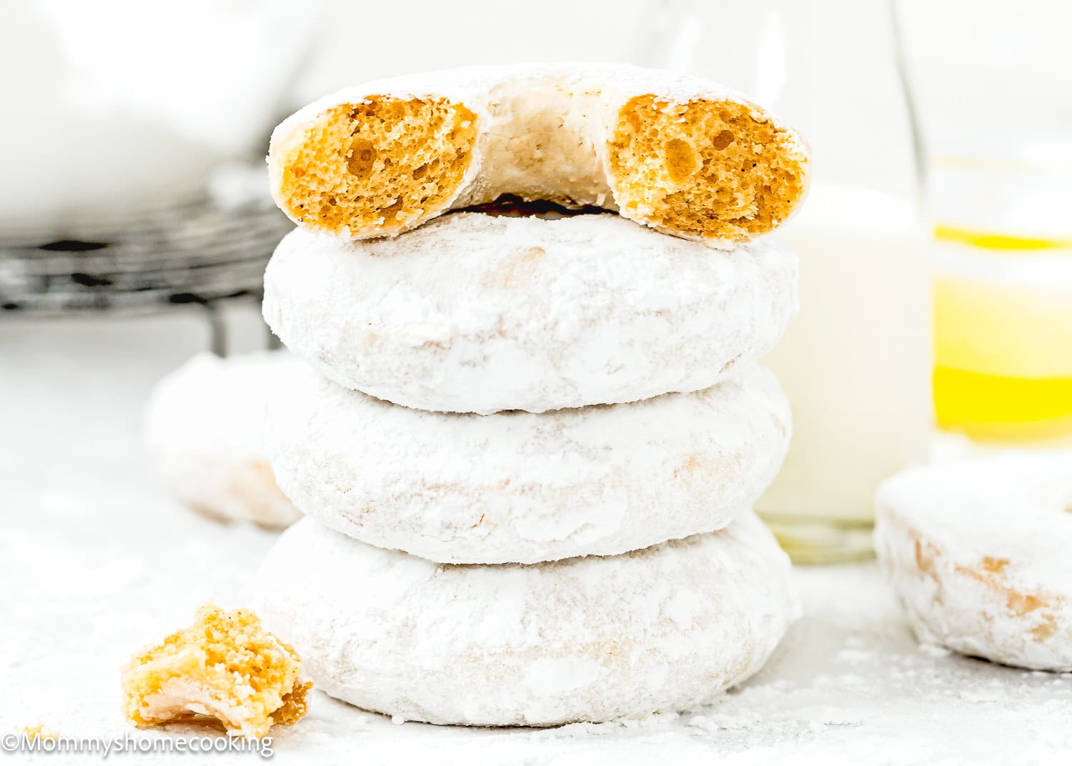 stack of four Eggless Old Fashioned Powdered Sugar Donuts showing its inside texture.