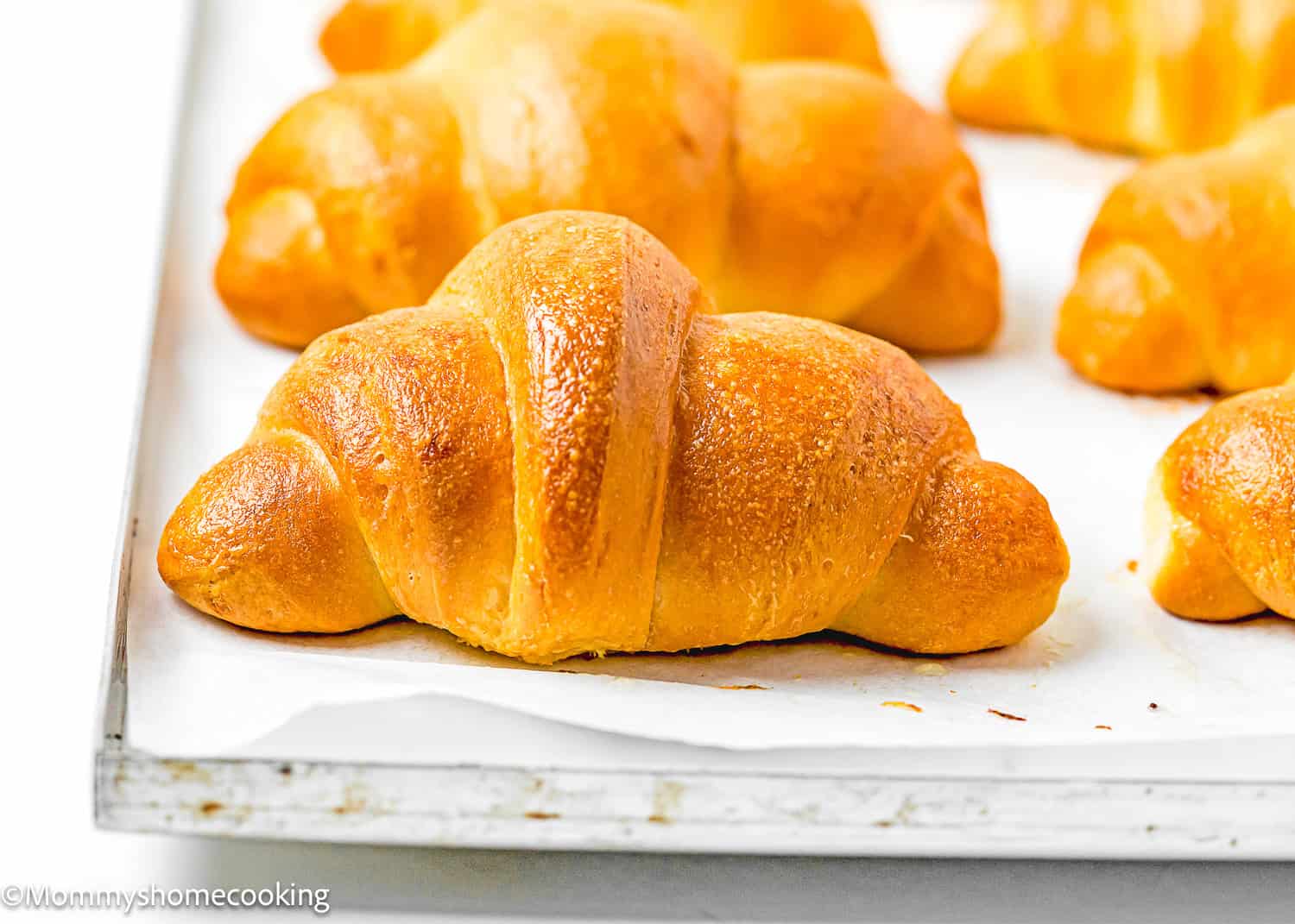 baked Homemade Eggless Crescents Rolls on a baking tray.