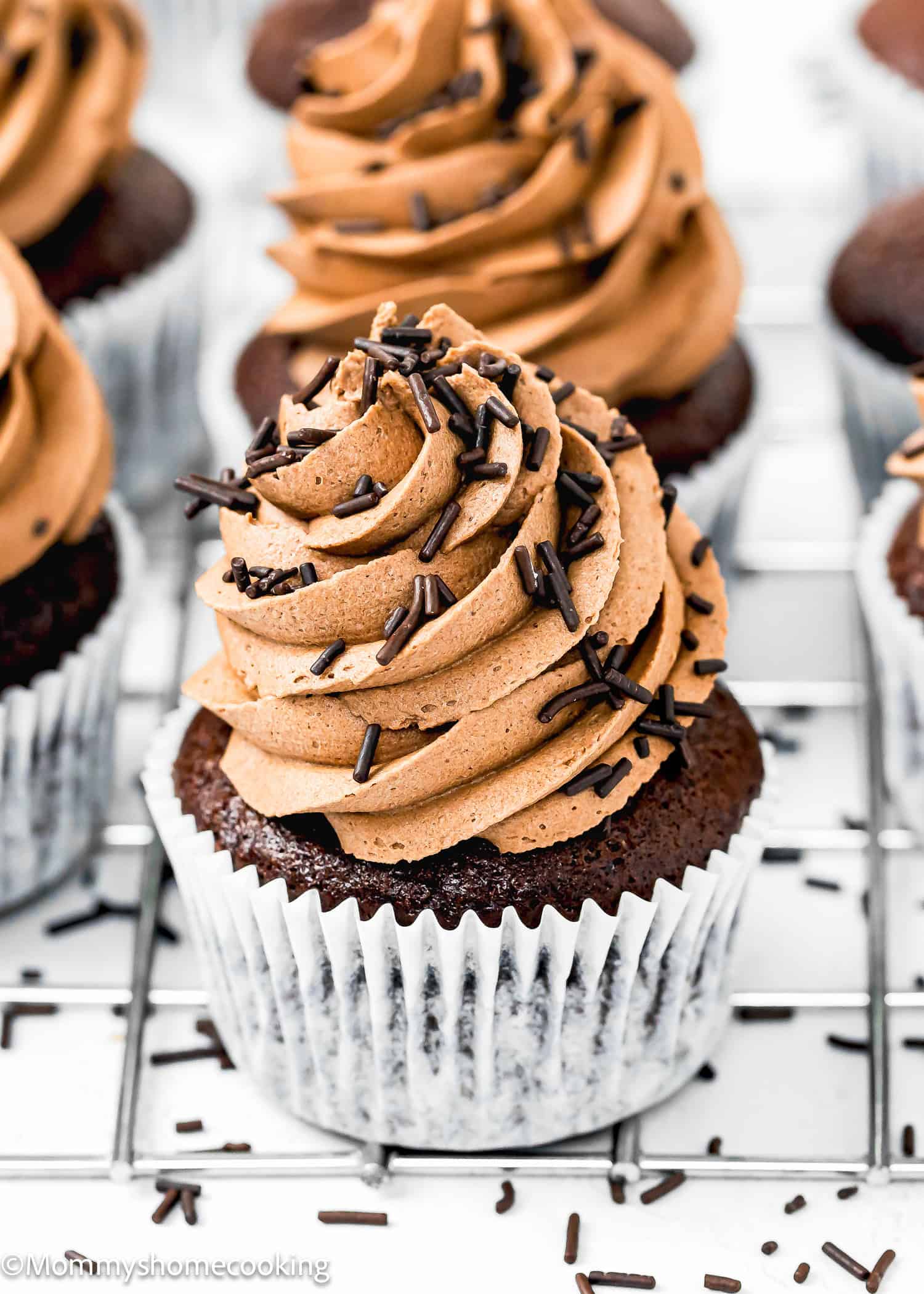 Easy egg-free and dairy-free Chocolate Cupcakes with chocolates frosting and chocolate sprinkles.